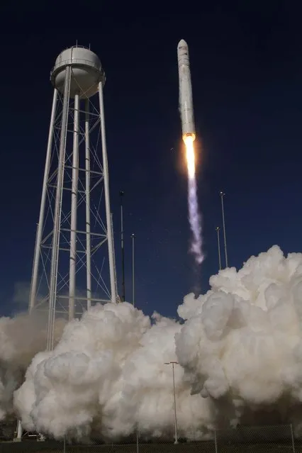 An Orbital Sciences Corp. Antares rocket lifts off from the NASA facility on Wallops Island Virginia, on April 21, 2013. The rocket will eventually deliver supplies to the International Space Station. (Photo by Steve Helber/Associated Press)