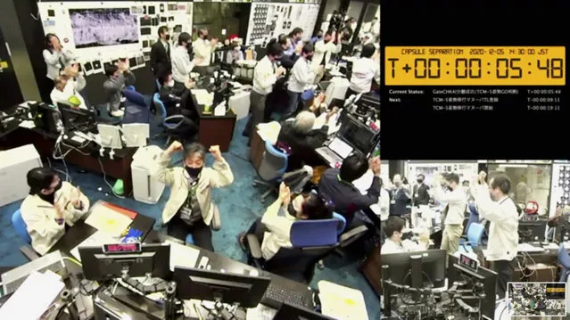 In this image made from video provided by the Japan Aerospace Exploration Agency (JAXA), its members react at the command center in Sagamihara, west of Tokyo, Saturday, December 5, 2020, after JAXA officials confirmed the successful separation of a capsule from the Hayabusa2 spacecraft. Japan’s space agency said the Hayabusa2 spacecraft successfully separated the capsule and sent it toward Earth to deliver samples from a distant asteroid that could provide clues to the origin of the solar system and life on our planet. (Photo by JAXA via AP Photo)