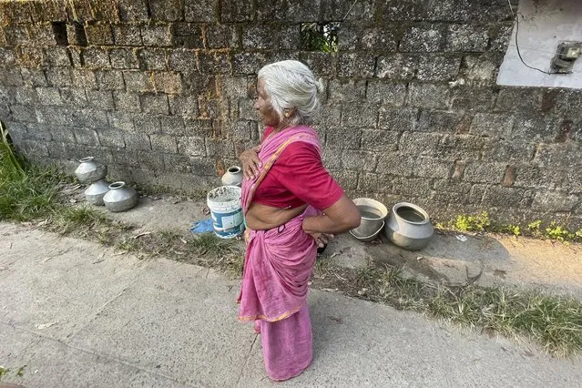 Maryamma Pillai takes a brief break from carrying pots of water to her home in the Chellanam area of Kochi, Kerala state, India, on March 1, 2023. Pillai is among residents who wait on a truck nearly every day to get clean water. (Photo by Uzmi Athar/Press Trust of India via AP Photo)