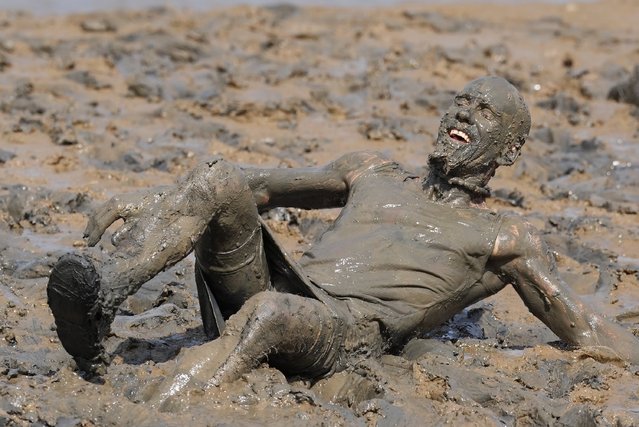 A competitor takes part in the annual Maldon Mud Race, a charity event to race across the bed of the River Blackwater in Maldon, Essex, UK on Sunday, June 2, 2024. (Photo by Gareth Fuller/PA Images via Getty Images)
