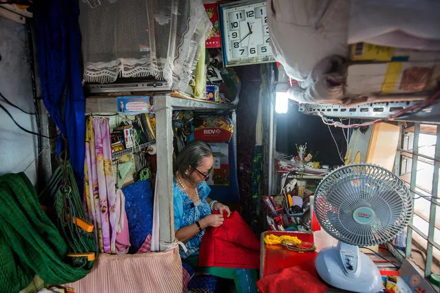 Nguyen Thi Tanh, 75, is seen sewing in her 6.7- square- meter home in Ho Chi Minh City on April 24, 2018. (Photo by Thanh Nguyen/AFP Photo)