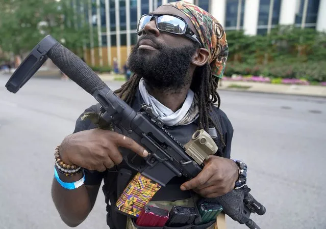 A supporter of an all-black militia group called NFAC is seen during a rally, in Louisville, Kentucky, U.S. July 25, 2020. A group of heavily armed Black protesters marched through Louisville, Kentucky demanding justice for Breonna Taylor, a Black woman killed in March by police officers who burst into her apartment. (Photo by Bryan Woolston/Reuters)