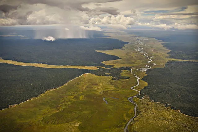 “Rains On The Plains Of Angola”. One can't help but to wonder what this river must have looked like eons ago. Now only a trickle of its former self but still a wondrous in its beauty. Location: North Eastern Angola, Africa. (Photo and caption by Rob McIntyre/National Geographic Traveler Photo Contest)