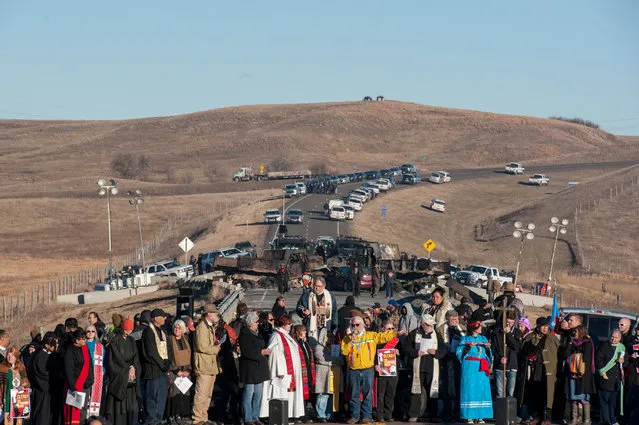Members of the clergy from across the United States participate in a prayer circle in front of a bridge where demonstrators are facing off against police during a protest of the Dakota Access pipeline near the Standing Rock Indian Reservation near Cannonball, North Dakota November 3, 2016. (Photo by Stephanie Keith/Reuters)