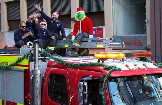 A firefighter dressed as the Grinch takes part in the Christmas season celebrations in Valparaiso, Chile, on December 21, 2024. (Photo by Rodrigo Garrido/Reuters)