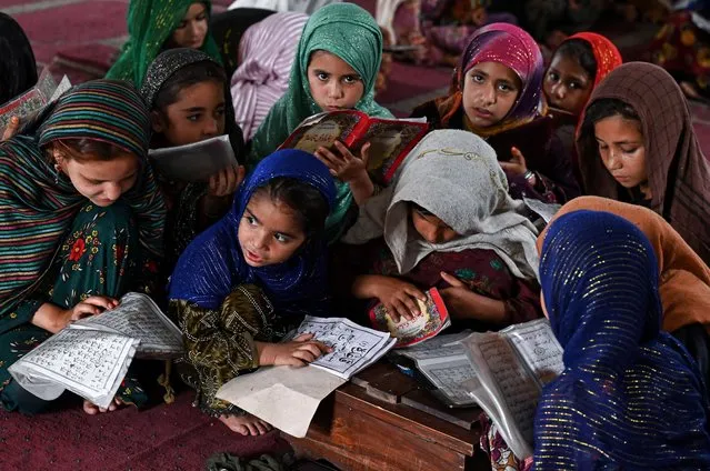 Children recite holy book Koran at a mosque in Lahore on June 18, 2023. (Photo by Arif Ali/AFP Photo)