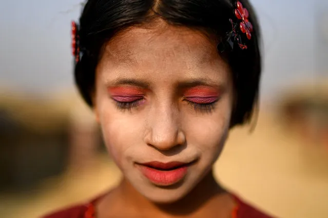 A Rohingya refugee girl named Amina poses for a photograph as she wears thanaka paste at Kutupalong camp in Cox's Bazaar, Bangladesh, March 30, 2018. (Photo by Clodagh Kilcoyne/Reuters)