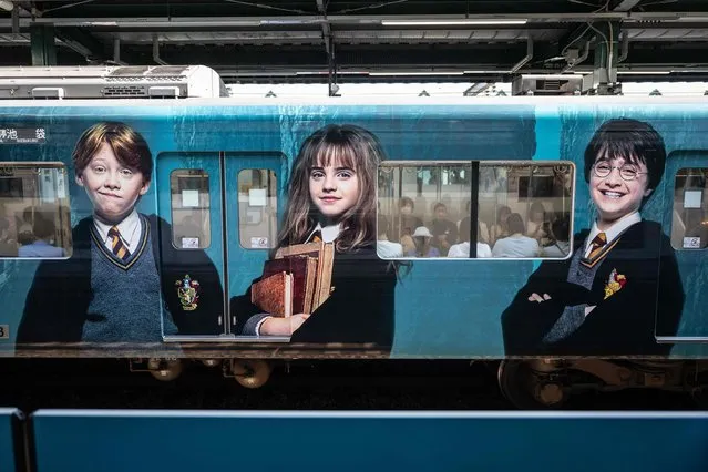A train adorned with Harry Potter characters are seen at Nerima station near the theme park “Warner Bros. Studio Tour Tokyo – The Making of Harry Potter” in Tokyo on June 16, 2023. (Photo by Yuichi Yamazaki/AFP Photo)