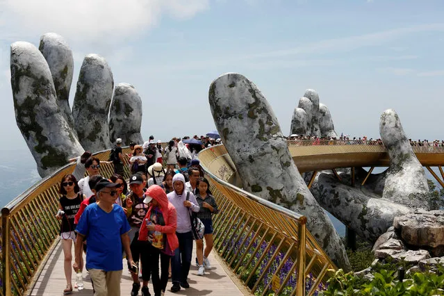 Tourists walk along Gold Bridge on Ba Na hill near Danang city, Vietnam on August 1, 2018. (Photo by Reuters/Kham)