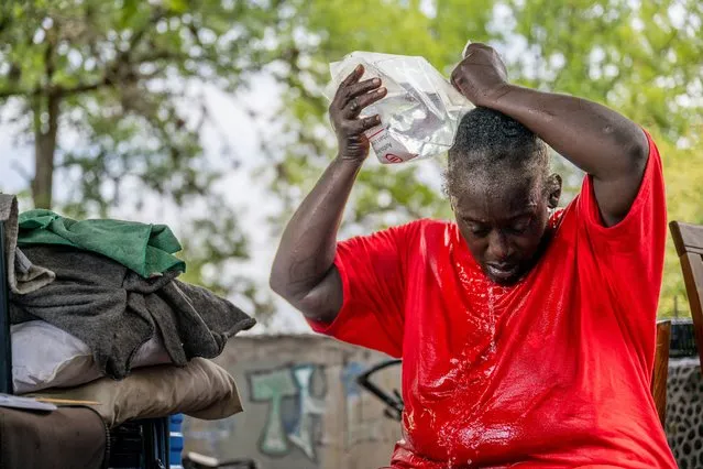 Andrea Washington pours water on herself in the Hungry Hill neighborhood on July 11, 2023 in Austin, Texas. Record-breaking temperatures continue soaring as prolonged heatwaves sweep across the Southwest of the country. (Photo by Brandon Bell/Getty Images)