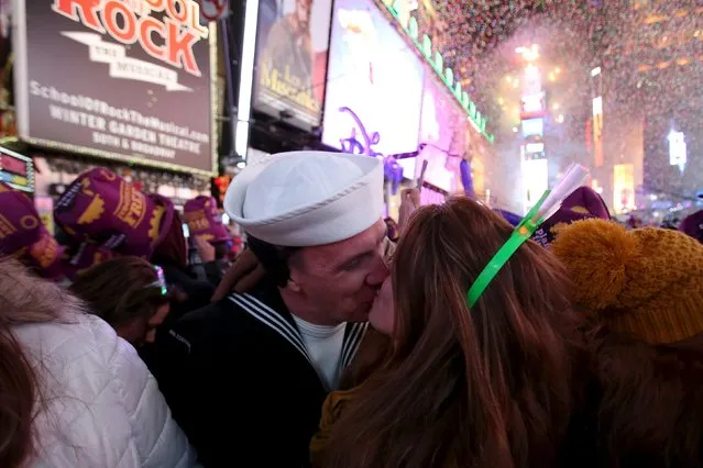 David Petrusaitis and Jacqueline Patchen kiss after midnight during New Year celebrations in Times Square in the Manhattan borough of New York January 1, 2016. (Photo by Andrew Kelly/Reuters)