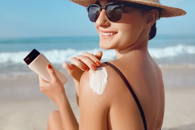 Girl using sunscreen to skin. Beautiful woman in bikini applying sun cream on tanned  shoulder. Sun protection. Skin and body care. (Photo by verona_S/Getty Images)