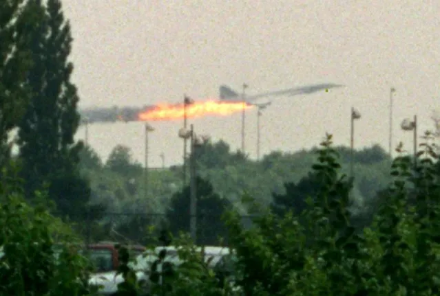Flames come out of the Air France Concorde seconds before it crashed in Gonesse near Paris Roissy airport in this July 25, 2000 file photo. All one hundred passengers and nine crew members on board the flight died. On the ground, four people were killed and one critically injured. (Photo by Andras Kisgergely/Reuters)
