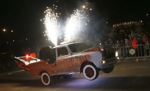 A member of the “Winged” motor theatre performs while driving a customized “Moskvich” Soviet made car during the annual “Winter Virage” motor sports festival dedicated to the Defender of the Fatherland Day on an embankment of the Yenisei River in Russia's Siberian city of Krasnoyarsk, February 23, 2015. (Photo by Ilya Naymushin/Reuters)