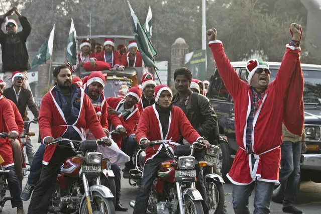 In this Sunday, December 20, 2015 file photo, Pakistani Christians wear Santa Claus jackets, during a rally in Lahore, Pakistan. (Photo by K.M. Chaudary/AP Photo)