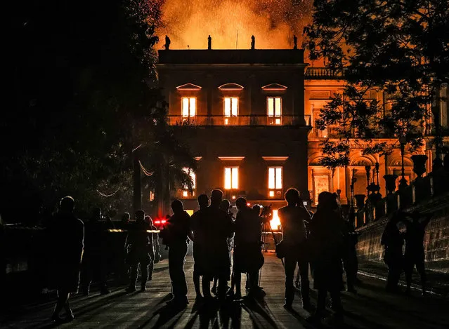 A fire burns at the National Museum of Brazil on September 2, 2018 in Rio de Janeiro, Brazil. The museum, which is tied to the Rio de Janeiro federal university and the Education Ministry, was founded in 1818 by King John VI of Portugal. It houses several landmark collections including Egyptian artefacts and the oldest human fossil found in Brazil.  Its collection include more than 20 million items ranging from archaeological findings to historical memorabilia. (Photo by Buda Mendes/Getty Images)