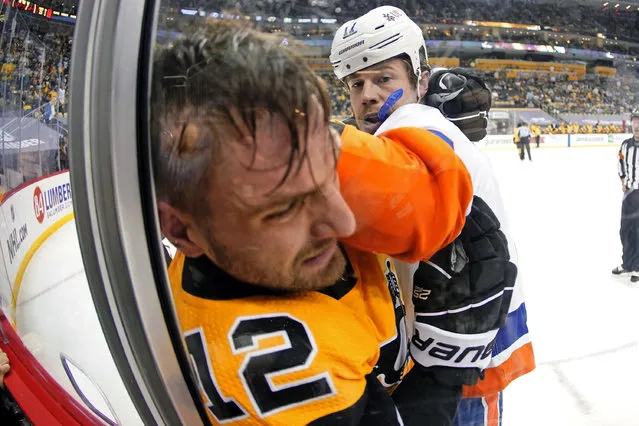 New York Islanders' Matt Martin (17) and Pittsburgh Penguins' Zach Aston-Reese (12) fight during the second period in Game 2 of an NHL hockey Stanley Cup first-round playoff series in Pittsburgh, Tuesday, May 18, 2021. Both players received a two-minute minor penalty. (Photo by Gene J. Puskar/AP Photo)