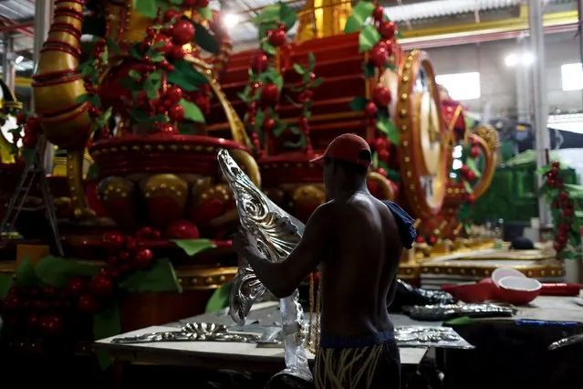 A worker prepares part of a carnival float at the Grande Rio Samba school, in preparation for the annual carnival parade, in Rio de Janeiro, Brazil, January 26, 2016. (Photo by Pilar Olivares/Reuters)