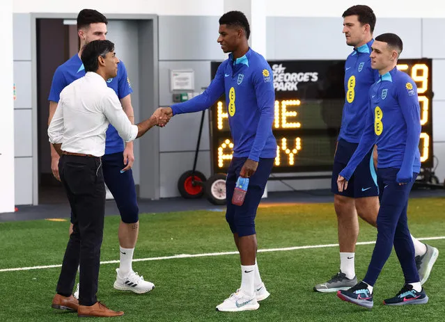 Britain's Prime Minister Rishi Sunak (2L) meets England's striker Marcus Rashford (C), England's midfielder Declan Rice (L), England's defender Harry Maguire (2R) and England's midfielder Phil Foden during an England training session at St George's Park in Burton-on-Trent, central England, on October 10, 2023. Seven years after awarding Euro-2024 to Germany, UEFA announced on October 10, 2023 the hosts for the next two editions: The United Kingdom and Ireland are due to host the tournament together in 2028, followed by the unprecedented tandem of Italy and Turkey in 2032. (Photo by Darren Staples/Pool via AFP Photo)