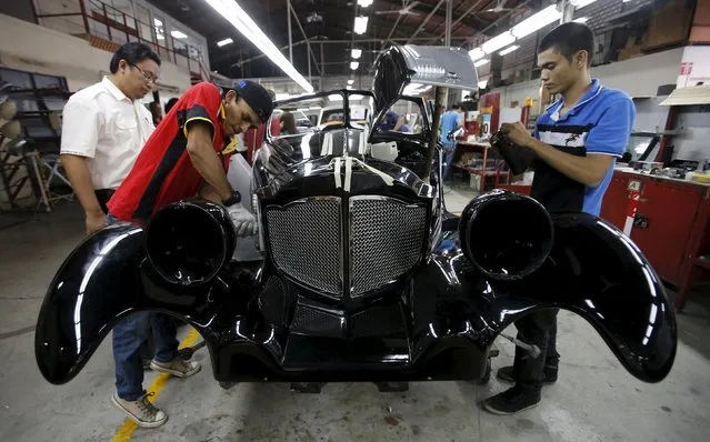 Workers refurbish a Bufori MKII Roadster at its plant in Kuala Lumpur in this September 10, 2012 file photo.  Malaysia is expected to report PMI numbers this week. (Photo by Bazuki Muhammad/Reuters)