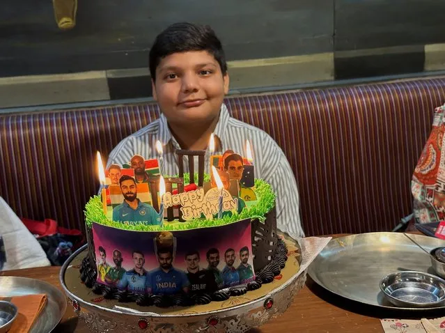 Aaron Indrekar celebrates his 13th birthday with a cricket World Cup theme cake at a restaurant in Ahmedabad, India on October 13, 2023. (Photo by Amit Dave/Reuters)