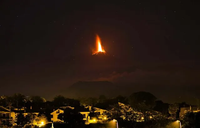 Lava flows during an eruption of Mt. Etna, seen from the village of Viagrande, near the Sicilian town of Catania on October 26, 2013. (Photo by Carmelo Imbesi/Associated Press)