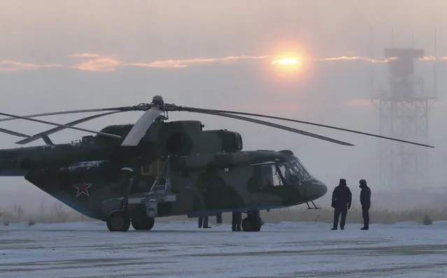 A search and rescue helicopter are seen before a flight to the landing area of the Soyuz MS-09 capsule with the International Space Station (ISS) crew onboard during sunrise in the town of Zhezkazgan, formerly known as Dzhezkazgan, Kazakhstan, Thursday, December 20, 2018. (Photo by Shamil Zhumatov/Pool Photo via AP Photo)