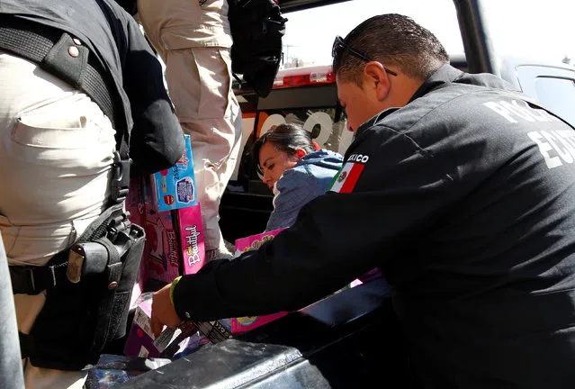 A woman is detained after she began looting a super market amid to protest against the rising prices of gasoline enforced by the Mexican government in Ecatepec, Mexico January 5, 2017. (Photo by Carlos Jasso/Reuters)