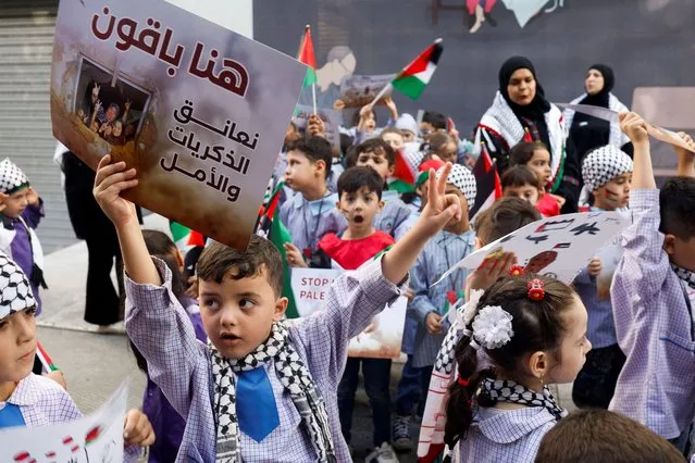 Children carry banners and flags during a demonstration in solidarity with Palestinians in Gaza, in front of the Red Cross offices in Beirut, Lebanon on November 7, 2023. (Photo by Alaa Al-Marjani/Reuters)
