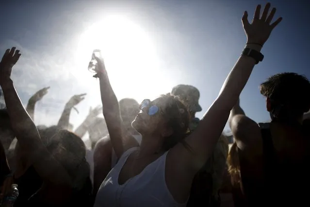 People cool off in misters at the Coachella Valley Music and Arts Festival in Indio, California April 12, 2015. (Photo by Lucy Nicholson/Reuters)