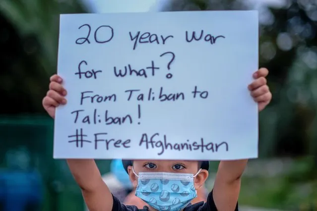 A boy holding a sign attends a vigil for Afghanistan outside the West LA Federal Building in Los Angeles, California, U.S. August 17, 2021. (Photo by Ringo Chiu/Reuters)