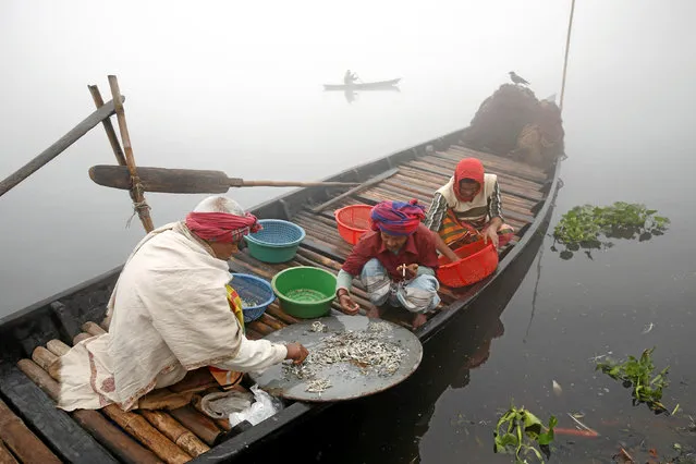 Fishermen sort out small fish which they have caught on a winter morning at the Buriganga River in Dhaka, Bangladesh January 7, 2017. (Photo by Mohammad Ponir Hossain/Reuters)