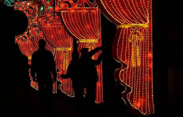 People are silhouetted against a light display during the The Magical Lantern Festival marking the Chinese new year at Chiswick House in London, Britain January 18, 2017. (Photo by Neil Hall/Reuters)