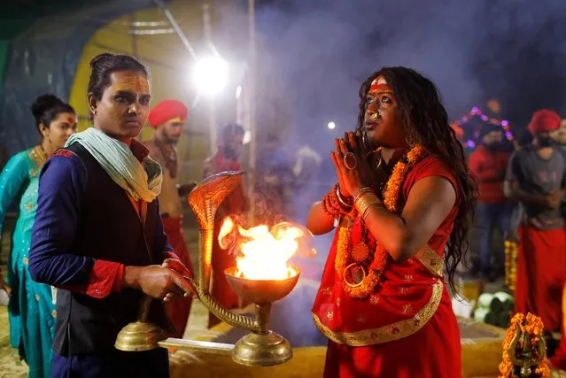 Members of the “Kinnar Akhara” congregation for transgender people pray inside their camp at “Kumbh Mela”, or the Pitcher Festival, in Prayagraj, previously known as Allahabad, India, February 2, 2019. (Photo by Anushree Fadnavis/Reuters)