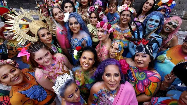 Women who were victims of breast cancer pose for a picture during the fifth edition of “A brushstroke for life” in Guadalajara, Mexico, on September 9, 2021. “A brushstroke for life” is an altruistic project where 52 survivors, both women and men, participate in order to make this disease visible to the world. (Photo by Ulises Ruiz/AFP Photo)