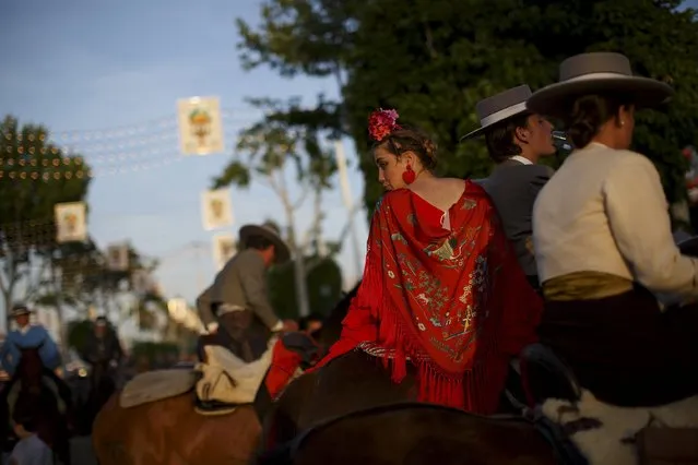 Riders wearing Andalusian outfits attend the traditional Feria de Abril (April fair) in the Andalusian capital of Seville, southern Spain, April 22, 2015. (Photo by Marcelo del Pozo/Reuters)