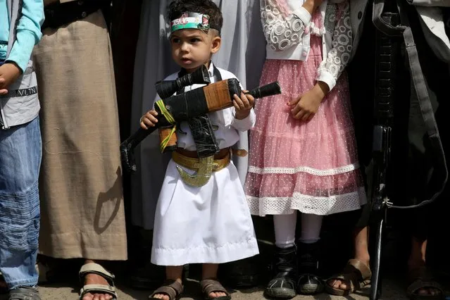 A boy carries a toy rifle during a demonstration against the continued Israeli offensive on the Gaza Strip, in Sanaa, Yemen on November 3, 2023. (Photo by Khaled Abdullah/Reuters)