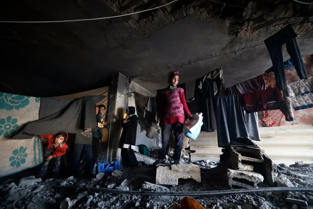 Displaced Palestinian children take shelter inside a building damaged during Israeli bombardment in Rafah in the southern Gaza Strip on January 17, 2024, amid ongoing battles between Israel and the Palestinian militant group Hamas. (Photo by AFP Photo)