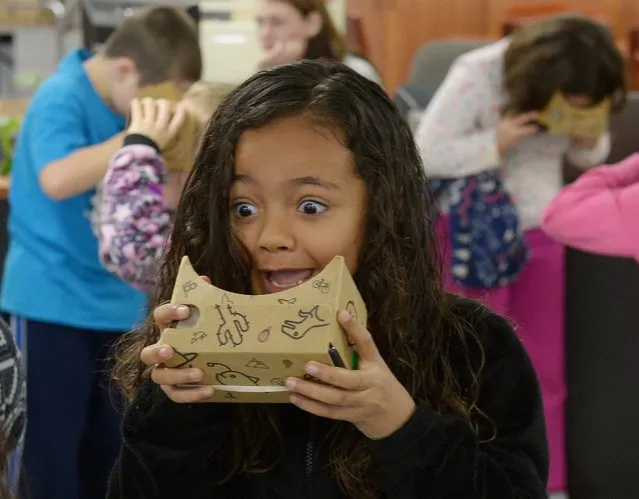 Rivermill Academy second grader Alexis Bennett reacts after experiencing a virtual reality panorama via Google's expeditions pioneer program in the media center at the school in Graham, NC Tuesday, March 8, 2016. (Photo by Sam Roberts/Burlington Times-News via AP Photo)