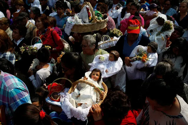 People carry dressed-up dolls representing baby Jesus during the Feast of Candelaria celebration, where elaborate effigies of young Jesus are carried to be blessed 40 days after his birth, in Xochimilco neighborhood in Mexico City, Mexico, February 2, 2017. (Photo by Carlos Jasso/Reuters)
