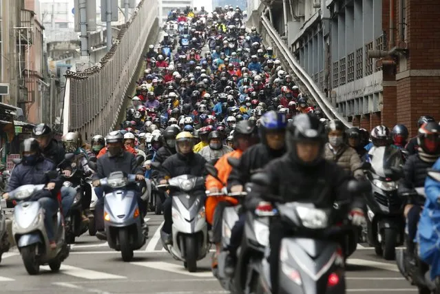 Motorists ride to work on a bridge during morning rush hour in Taipei, Taiwan March 14, 2016. (Photo by Tyrone Siu/Reuters)