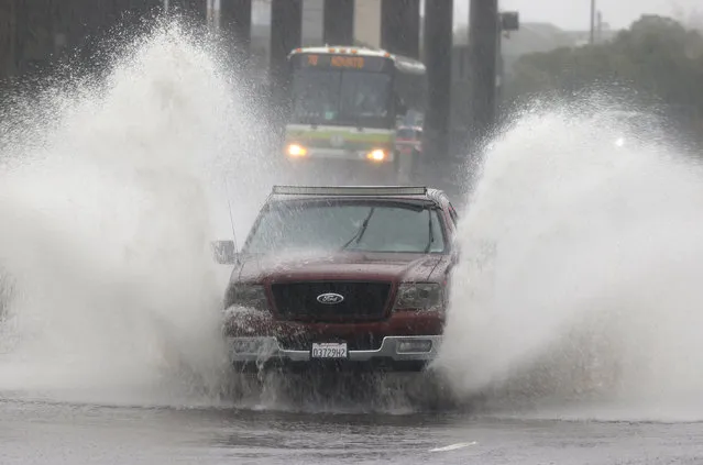 Water kicks up as a truck drives on a flooded street on October 24, 2021 in Mill Valley, California. A category 5 atmospheric river is bringing heavy precipitation, high winds and power outages to the San Francisco Bay Area. The storm is expected to bring anywhere between 2 to 5 inches of rain to many parts of the area. (Photo by Justin Sullivan/Getty Images)