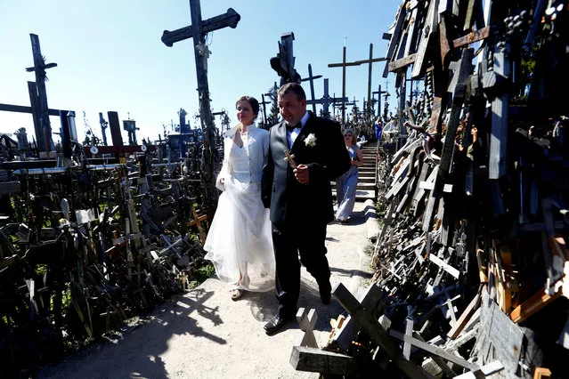 Newlyweds visit Hill of Crosses during Easter celebrations, near Siauliai, Lithuania on April 19, 2019. (Photo by Ints Kalnins/Reuters)