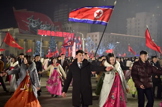 Youth and students take part in celebrations to welcome in the new year at Kim Il Sung Square in Pyongyang on December 31, 2023. (Photo by Kim Won Jin/AFP Photo)