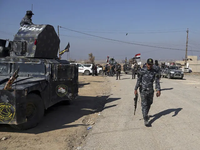 Iraqi Federal police deploy after regaining control of the town of Abu Saif, west of Mosul, Iraq, Wednesday, February 22, 2017. The battle for Mosul, backed by the U.S.-led coalition, has already driven the militants from the eastern half of the city, which is divided roughly in half by the Tigris River. (Photo by Khalid Mohammed/AP Photo)