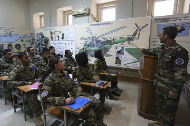 In this November 21, 2016 file photo, new Afghan air force pilots attend class at the air force university in Kabul, Afghanistan. Afghanistan may not be ready for peace unless it formulates a strategy for re-integration of Taliban fighters into society, combating corruption and reining in the country’s runaway narcotics problem, a U.S. watchdog said Wednesday, May 1, 2019. (Photo by Rahmat Gul/AP Photo/File)
