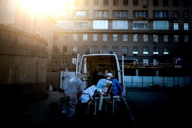 A patient is carried on a stretcher by healthcare workers outside Santa Maria hospital in Lisbon on January 7, 2021. Portugal reported a record 10,000 new coronavirus cases in 24 hours yesterday, and the government warned that its hospitals were under “enormous pressure” from the resurgence of the pandemic. (Photo by Patricia de Melo Moreira/AFP Photo)