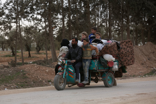 A Syrian family drives a vehicle in the northern Syrian town of al-Bab, Syria February 28, 2017. (Photo by Khalil Ashawi/Reuters)