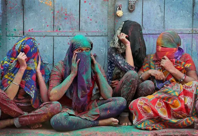 Women cover their faces during Holi celebrations in the town of Barsana in the state of Uttar Pradesh, India, March 6, 2017. (Photo by Cathal McNaughton/Reuters)