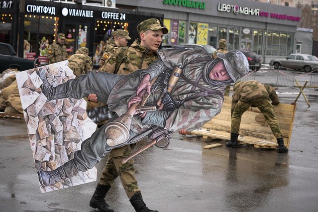 A military cadet carries a figure of a Nazi German soldier during a military festival dedicated to the upcoming Victory Day in World War II in St. Petersburg, Russia, Saturday, April 20, 2024. (Photo by Dmitri Lovetsky/AP Photo)